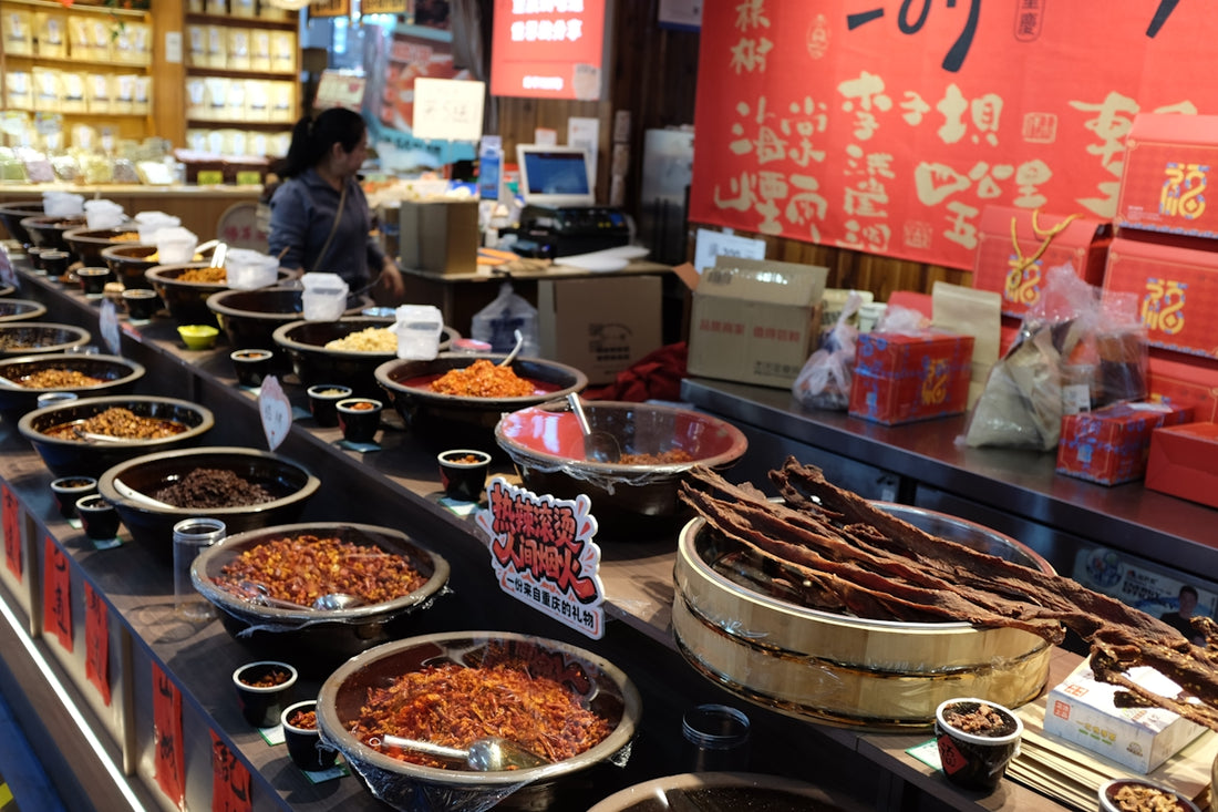 Bowls of spices and dried goods displayed in a market.