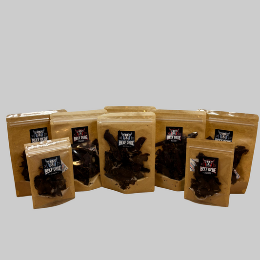 Set of brown packaging with beef jerky on a white surface